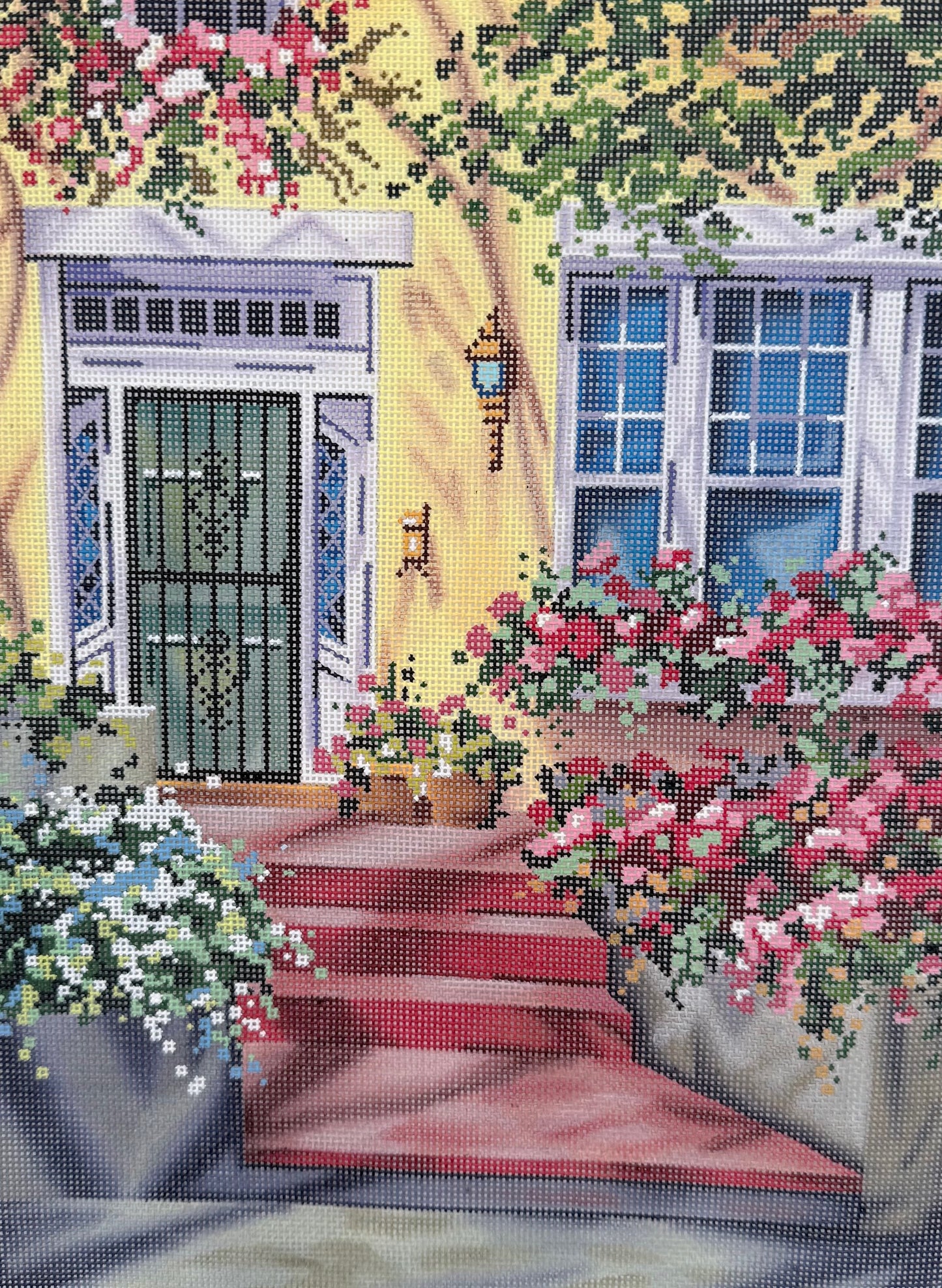 Green Door on Yellow House with Steps and Flowers