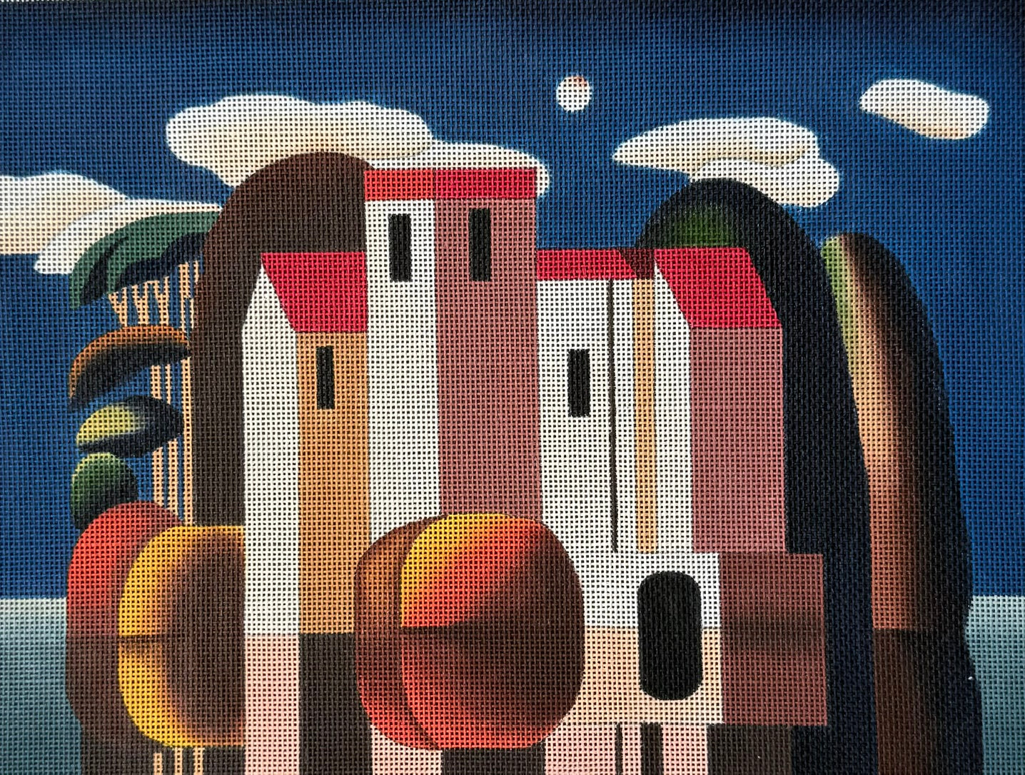 Tall Geometric Houses with Blue Sky and Clouds